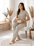 Woman sitting in a chair holding popcorn in a cozy living room.
