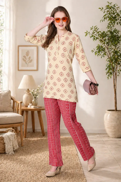 Woman wearing a patterned top and red pants in a living room setting